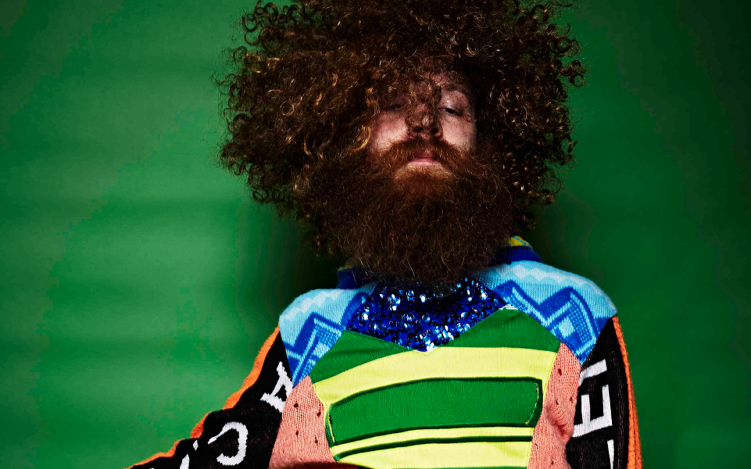 Pieter Ampe with afro, beard and colourful shirt