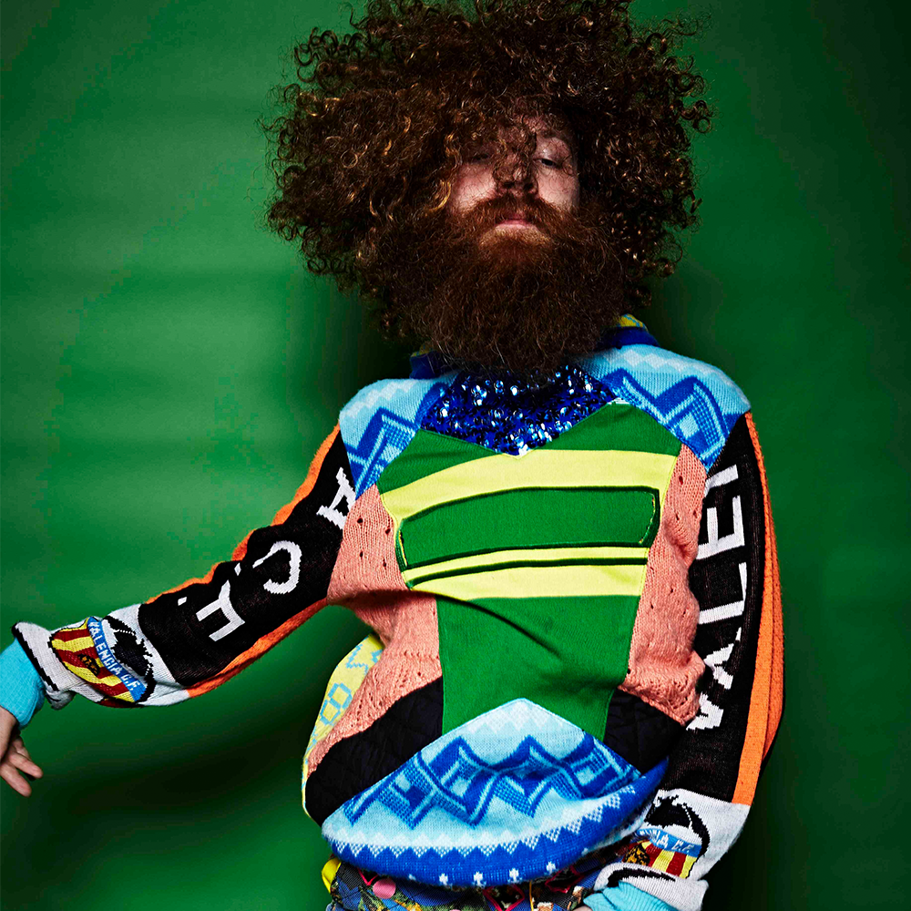 Pieter Ampe with afro, beard and colourful shirt