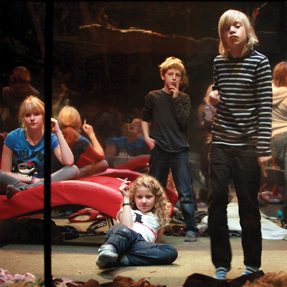 Group of young people on stage looking out at the audience