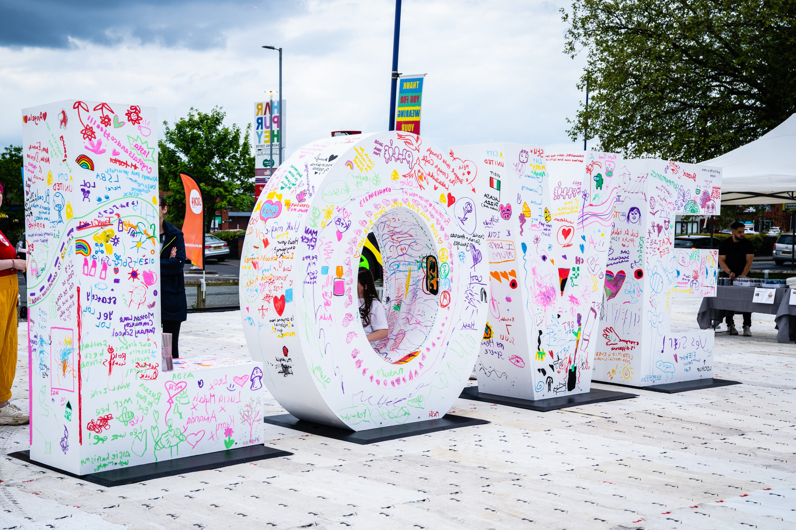 A large installation with the letters LOVE decorated by members of the community