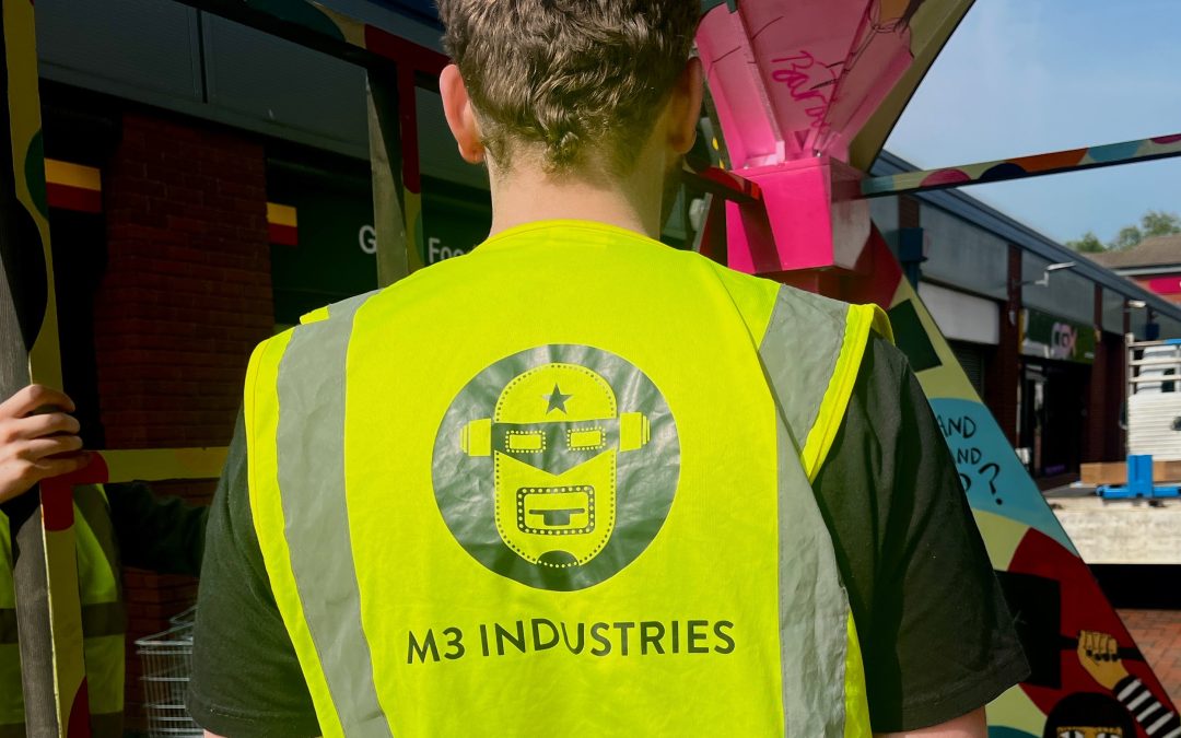 The image shows a member of the M3 Industries team wearing a high visibility vest working of the safe installation as part of SICK! Festival 2024